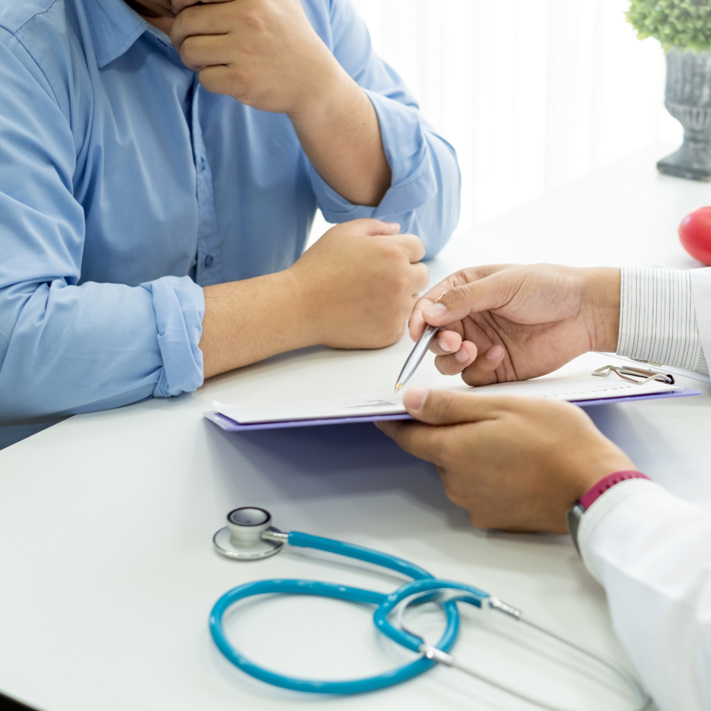 close up photo of doctor showing a document to a patient